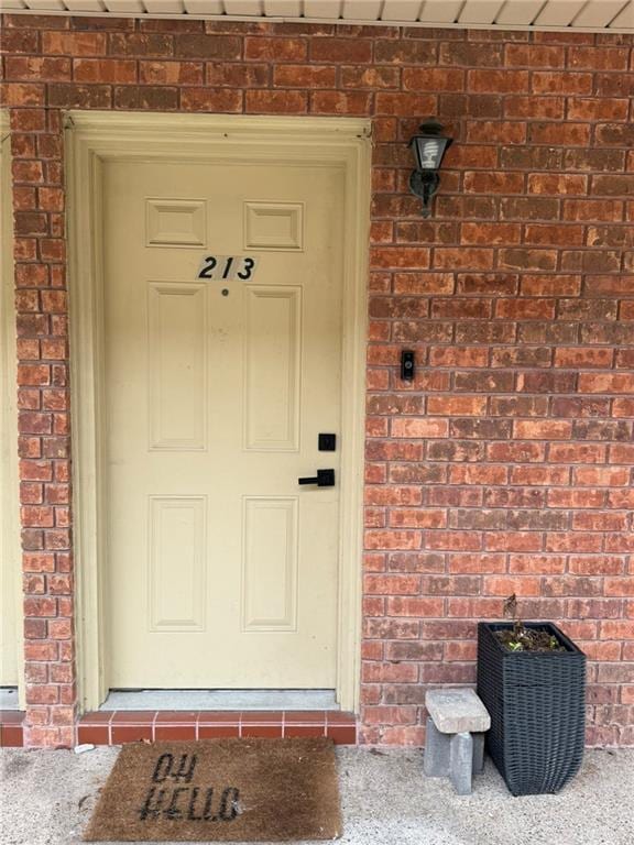 entrance to property with brick siding