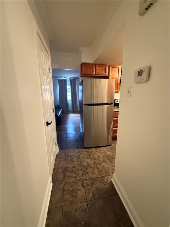 213 W Esplanade Ave Unit 213, Metairie, LA 70005 - corridor with crown molding, baseboards, and dark tile patterned floors