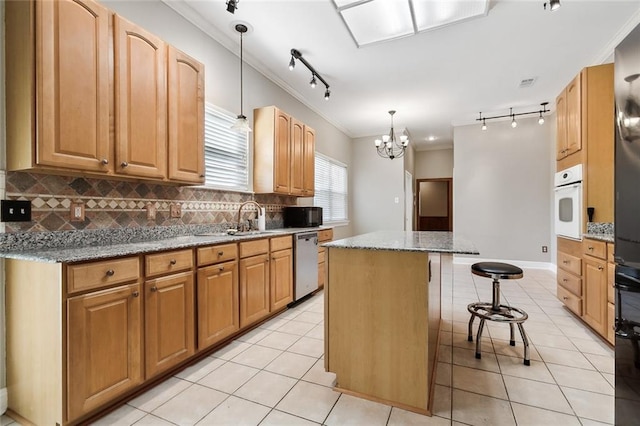 kitchen featuring a breakfast bar, light tile patterned floors, stainless steel dishwasher, a kitchen island, and oven