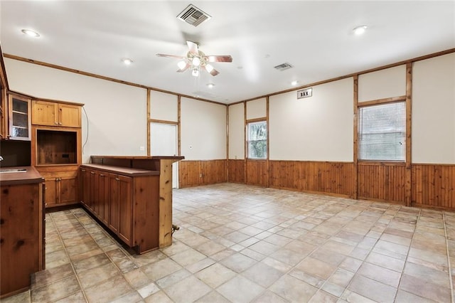 kitchen featuring wainscoting, a sink, and visible vents