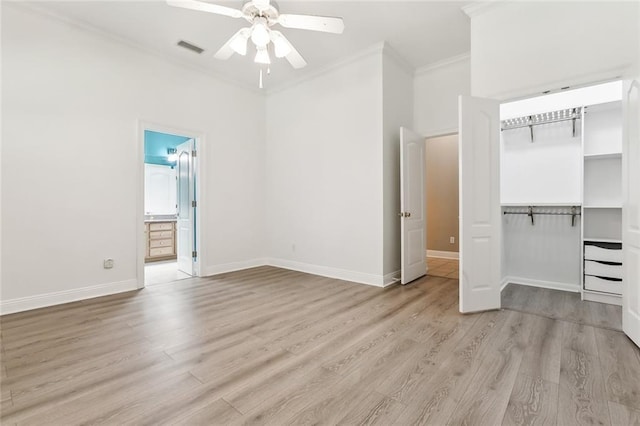 unfurnished bedroom featuring crown molding, baseboards, visible vents, and light wood-style floors