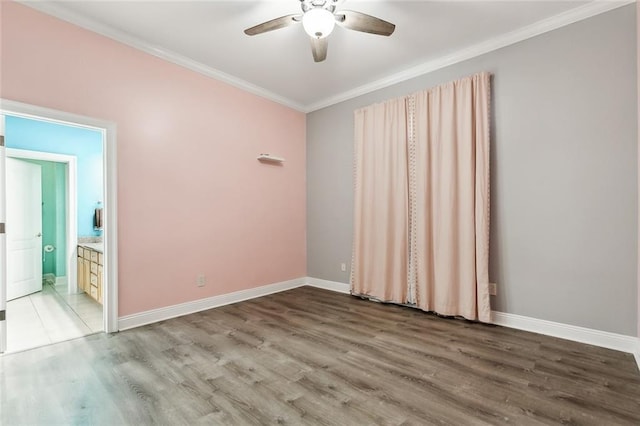 unfurnished room featuring ornamental molding, a ceiling fan, baseboards, and wood finished floors