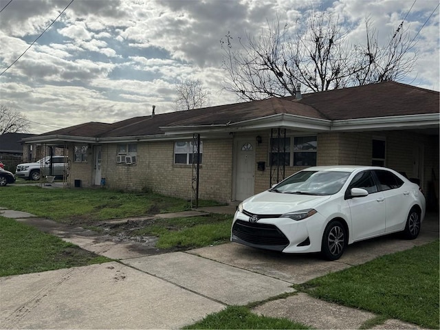 view of property exterior with brick siding and a lawn