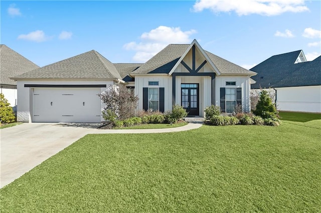 view of front of property featuring an attached garage, concrete driveway, french doors, board and batten siding, and a front yard