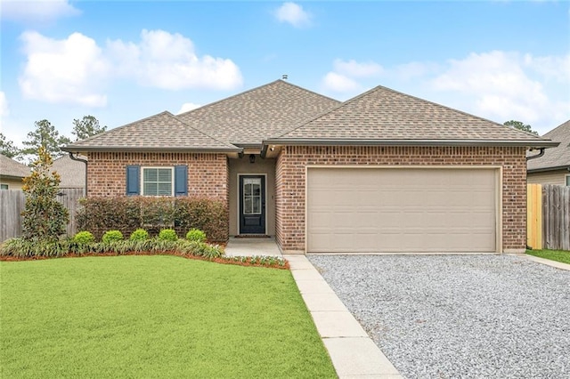 ranch-style house with brick siding, a shingled roof, a front yard, fence, and a garage