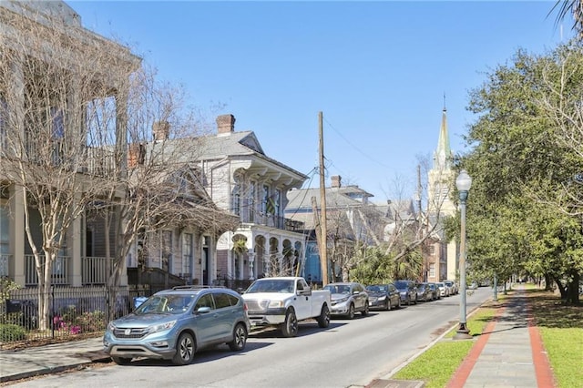 view of street with street lights, curbs, and sidewalks