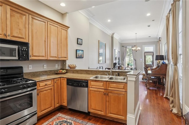 kitchen with appliances with stainless steel finishes, ornamental molding, a peninsula, a chandelier, and a sink