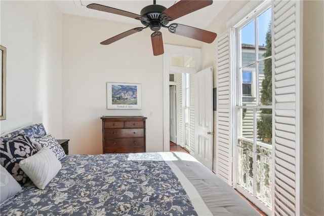 bedroom with access to outside and ceiling fan