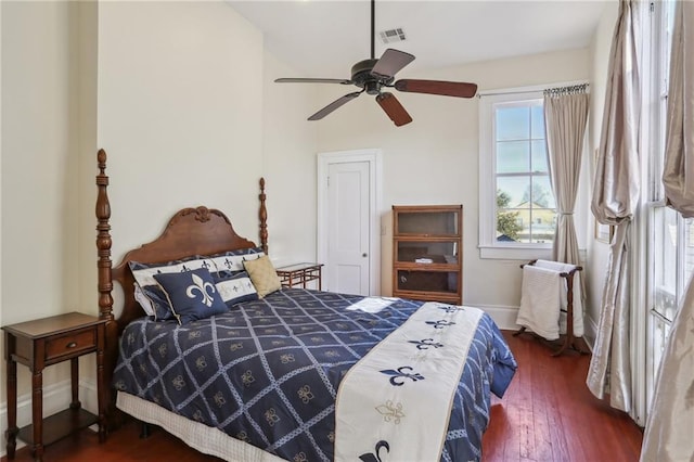 bedroom with hardwood / wood-style floors, a ceiling fan, visible vents, and baseboards