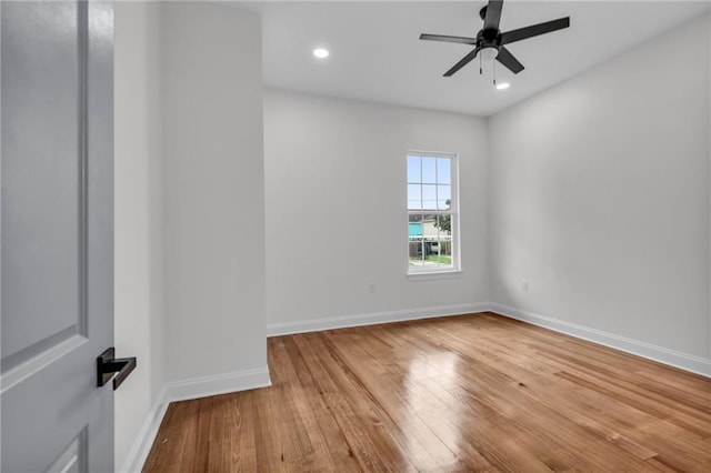 unfurnished room featuring recessed lighting, wood finished floors, a ceiling fan, and baseboards