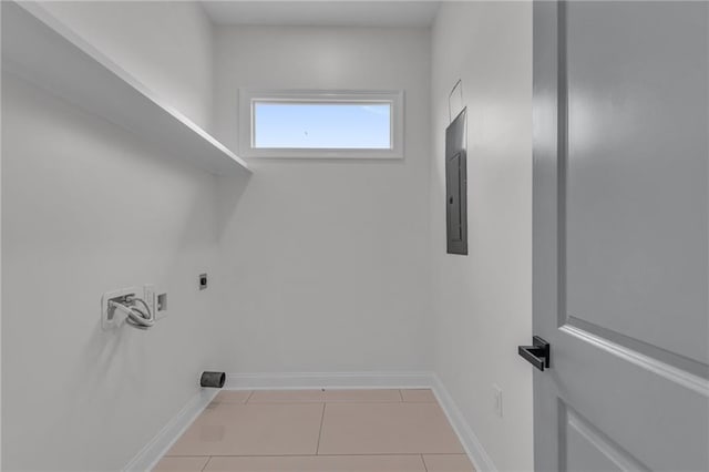 washroom with light tile patterned floors, hookup for a washing machine, electric dryer hookup, laundry area, and baseboards