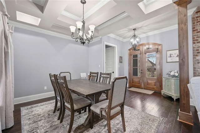 dining space with a chandelier, coffered ceiling, ornamental molding, and hardwood / wood-style floors