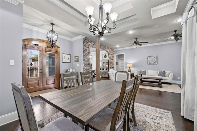 dining space with baseboards, dark wood-style flooring, crown molding, and french doors