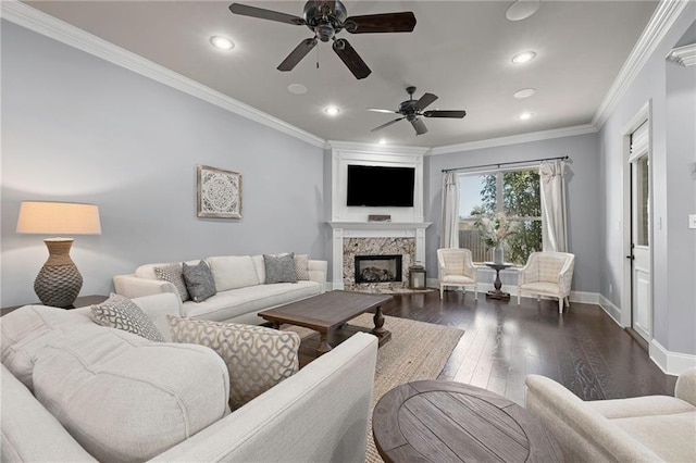 living room featuring recessed lighting, a premium fireplace, baseboards, ornamental molding, and dark wood-style floors