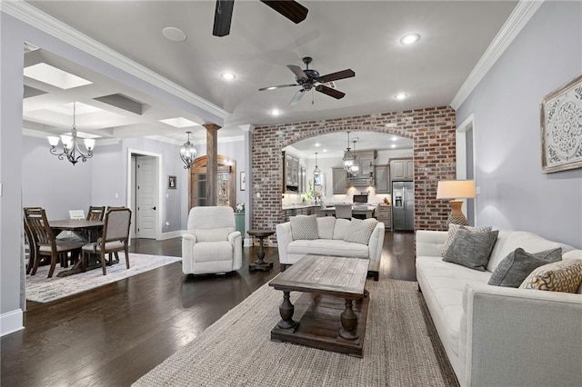 living room featuring arched walkways, crown molding, dark wood finished floors, recessed lighting, and ceiling fan with notable chandelier