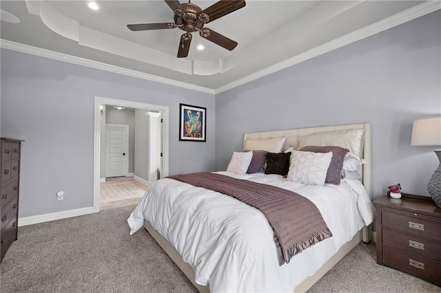 carpeted bedroom featuring a tray ceiling, baseboards, and recessed lighting