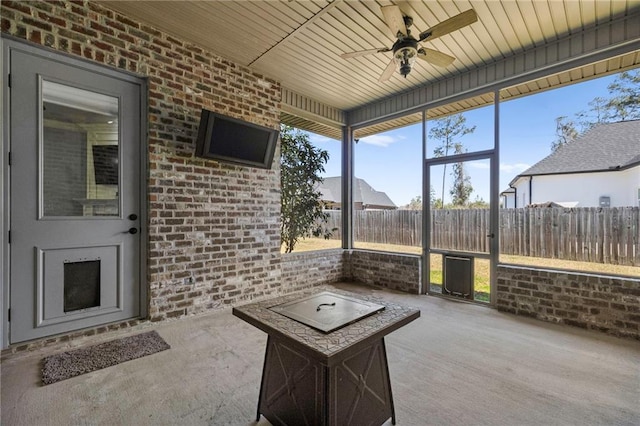 sunroom with ceiling fan and wood ceiling