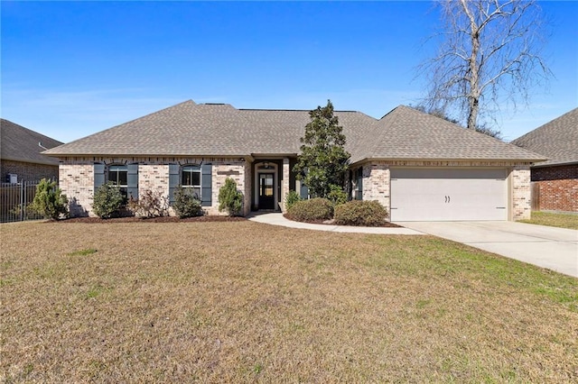 ranch-style home with a shingled roof, a front yard, brick siding, and driveway