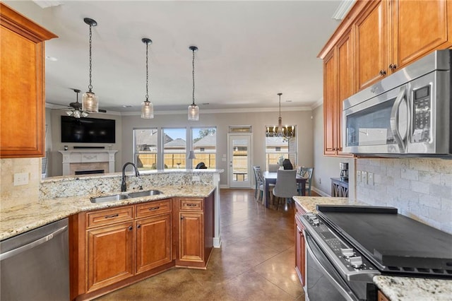 kitchen with stainless steel appliances, brown cabinets, and a sink