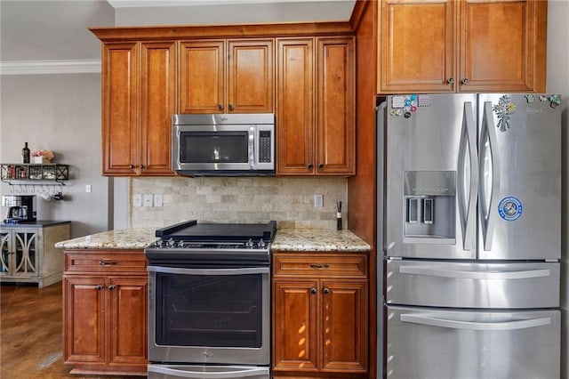 kitchen featuring brown cabinetry, tasteful backsplash, and stainless steel appliances