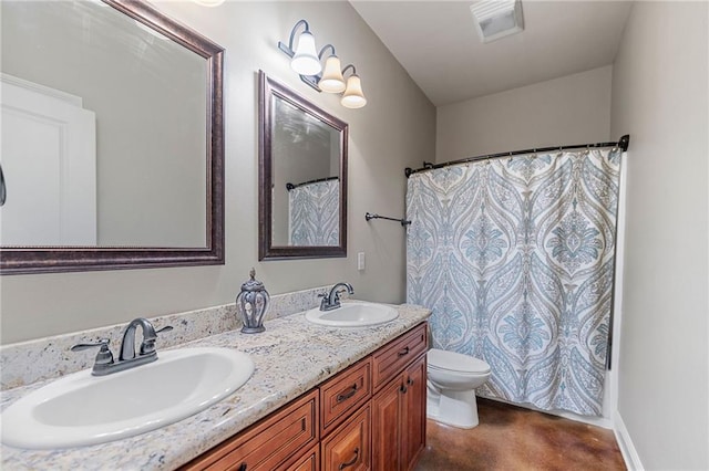 full bathroom with double vanity, a sink, and toilet