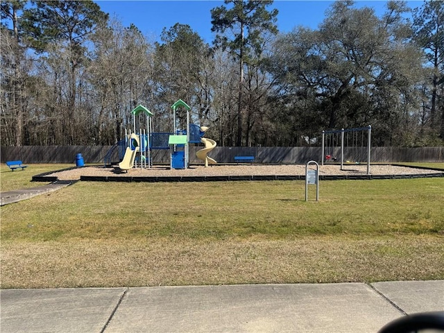 community play area with a yard and fence