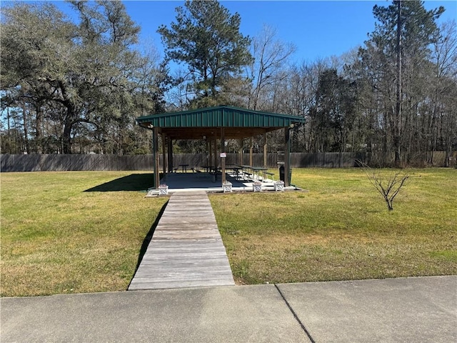 dock area featuring a gazebo, a yard, and fence