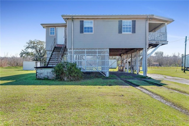 rear view of house featuring a lawn