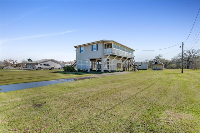 view of front of house featuring stairway and a front yard