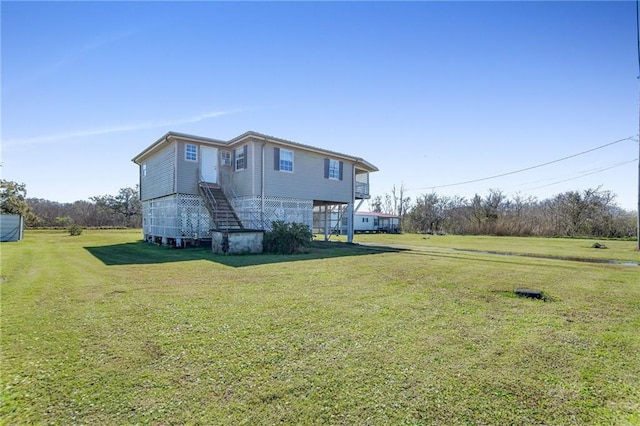 exterior space with stairs and a yard