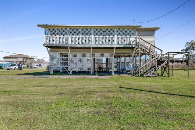 back of property with metal roof, stairway, a deck, and a yard