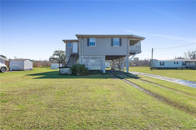 exterior space featuring a carport, stairway, a yard, and driveway