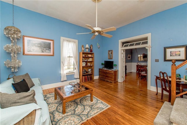 living area with ceiling fan, wood finished floors, and baseboards