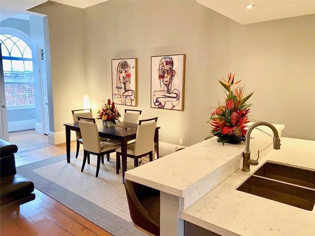 dining area featuring light wood-type flooring and baseboards