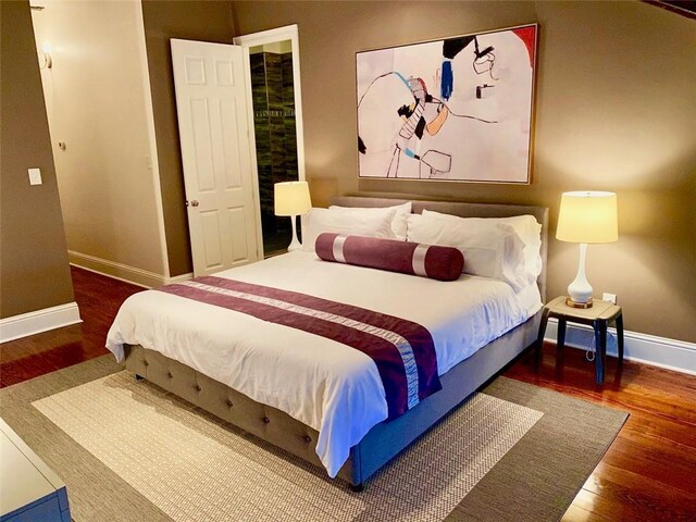 bedroom featuring baseboards and wood finished floors