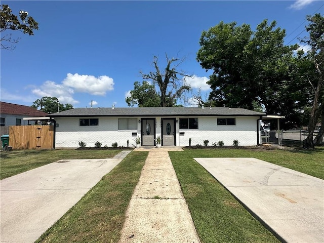 single story home with a gate, brick siding, fence, and a front lawn