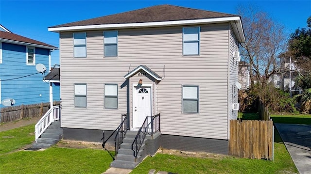 view of front of house featuring a front yard and fence