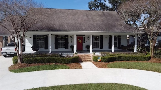 view of front of house featuring covered porch and roof with shingles