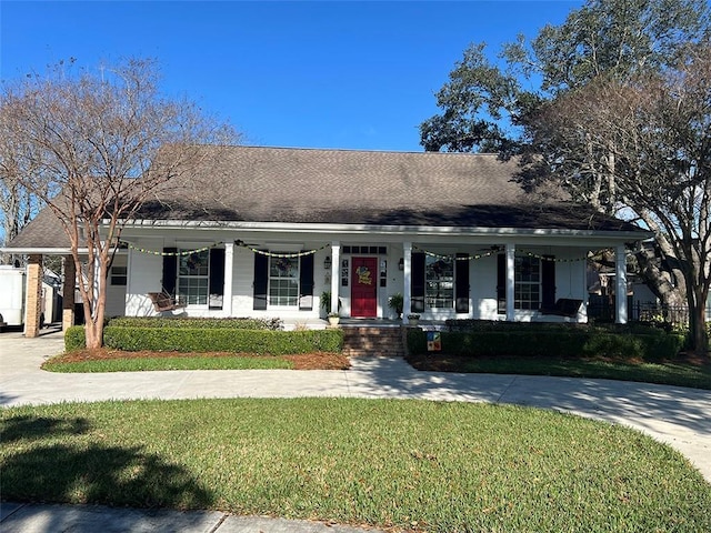 farmhouse inspired home featuring driveway, a shingled roof, covered porch, a carport, and a front yard