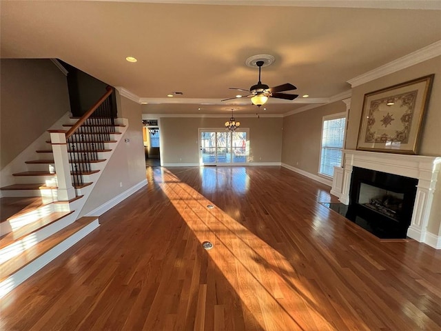 unfurnished living room with a fireplace with flush hearth, plenty of natural light, ornamental molding, and wood finished floors