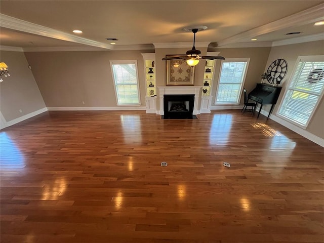 unfurnished living room featuring dark wood-style flooring, plenty of natural light, and a fireplace with flush hearth