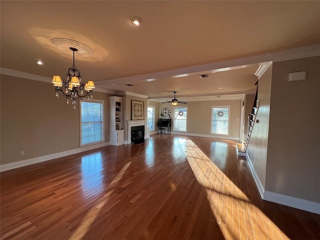 unfurnished living room with dark wood-type flooring, a fireplace, visible vents, baseboards, and crown molding