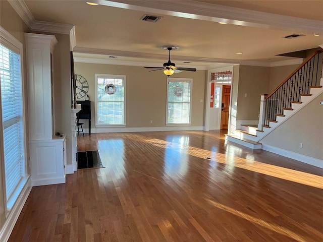 foyer entrance featuring ornamental molding, a wealth of natural light, and visible vents