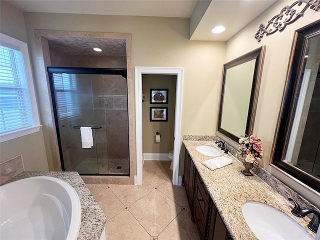 bathroom featuring a garden tub, a sink, and a shower stall