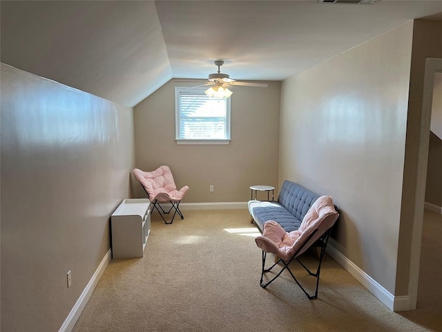 living area featuring carpet floors, lofted ceiling, visible vents, a ceiling fan, and baseboards