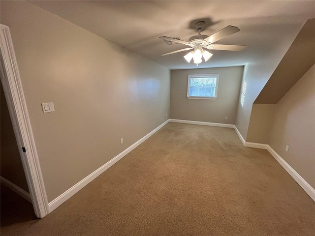 additional living space with light carpet, baseboards, and a ceiling fan