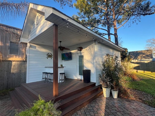 back of property with a patio area, ceiling fan, fence, and a wooden deck