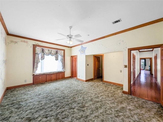 interior space featuring visible vents, baseboards, ceiling fan, ornamental molding, and carpet