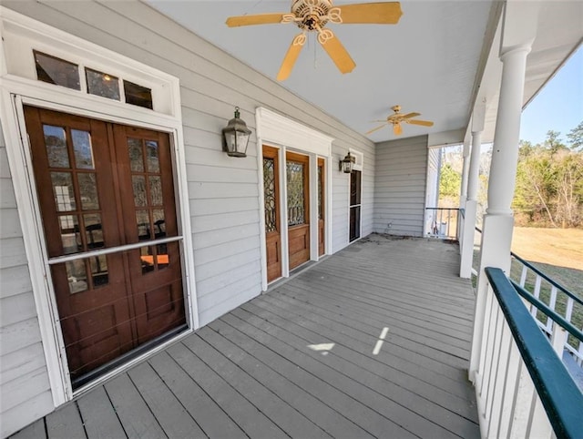 wooden deck featuring french doors and a ceiling fan