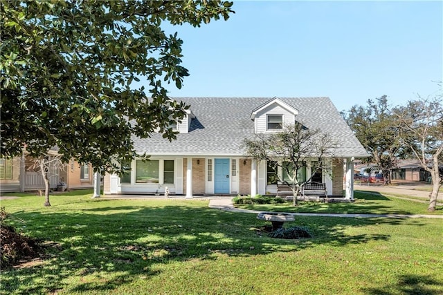 cape cod-style house with a front lawn, brick siding, covered porch, and roof with shingles